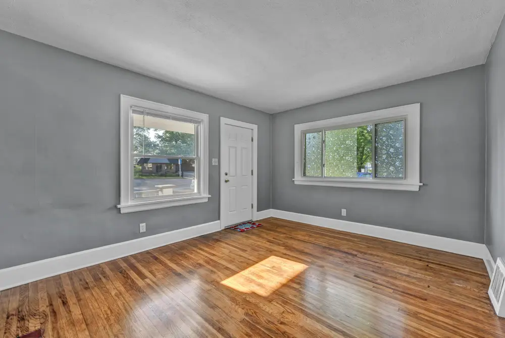 Empty room with fresh gray walls and white trim